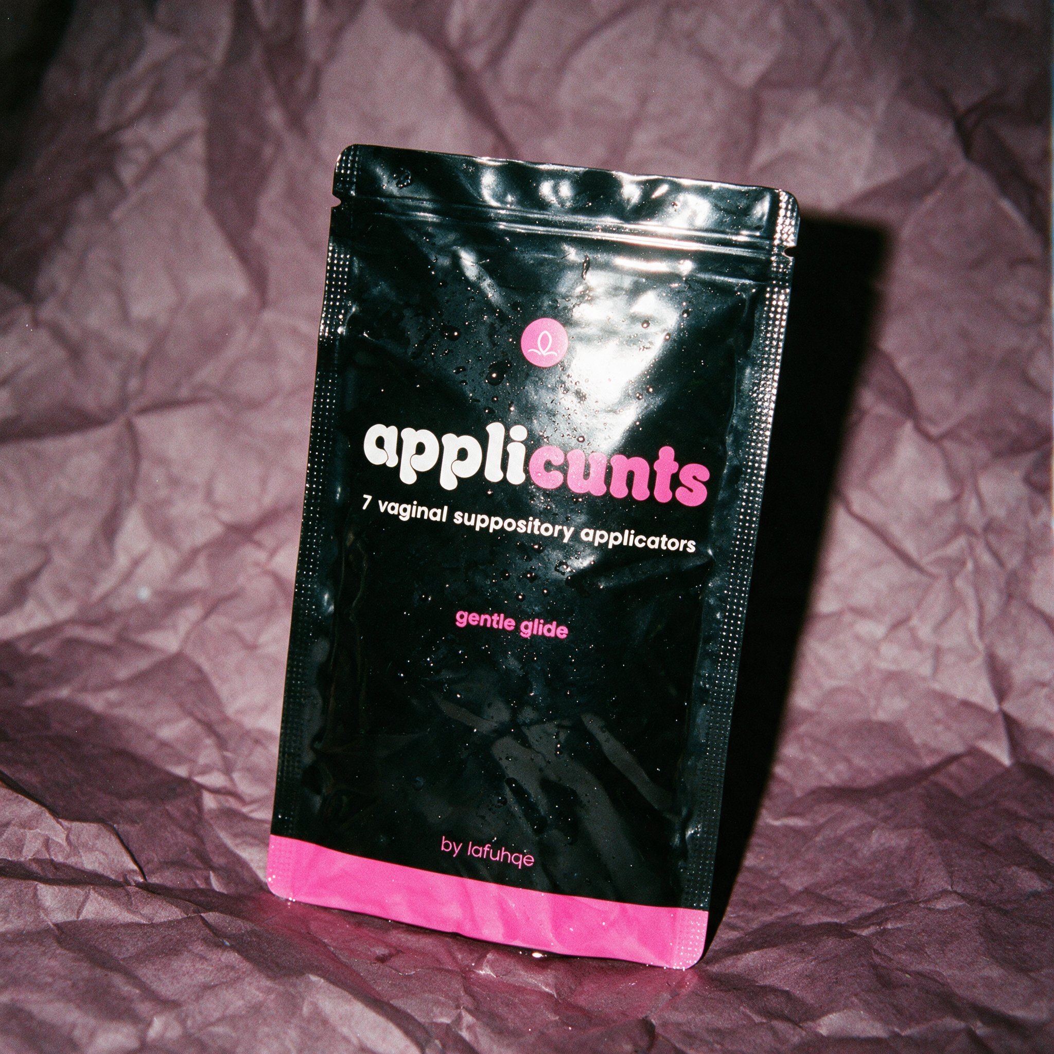 Applicunts suppository applicators pouch on dark mauve plum backdrop