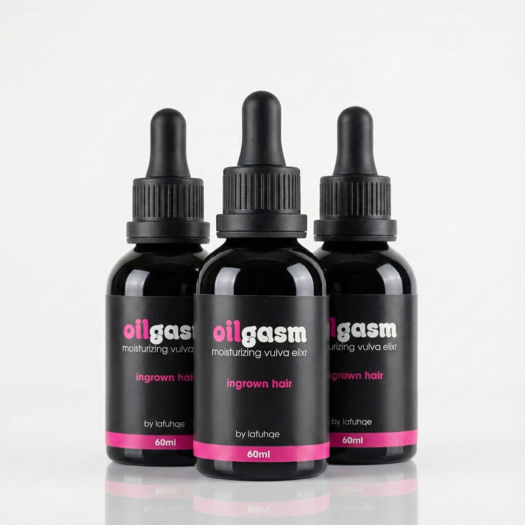 Three black bottles labeled 'oilgasm' on a light gray background